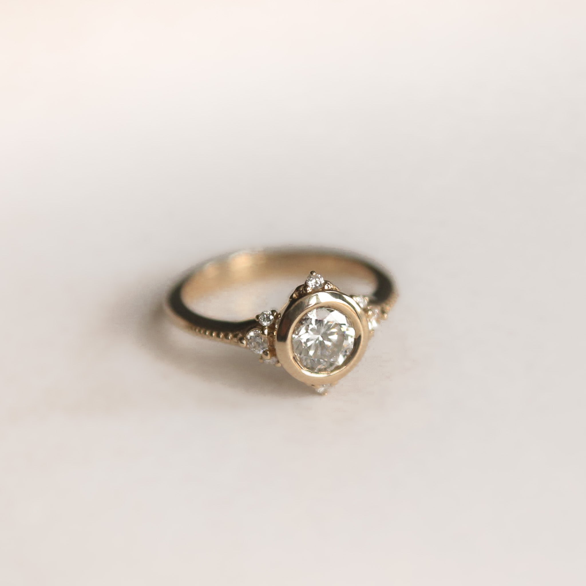 Round brilliant diamond engagement ring with tiny diamond accents - Cival Jewelry Milwaukee