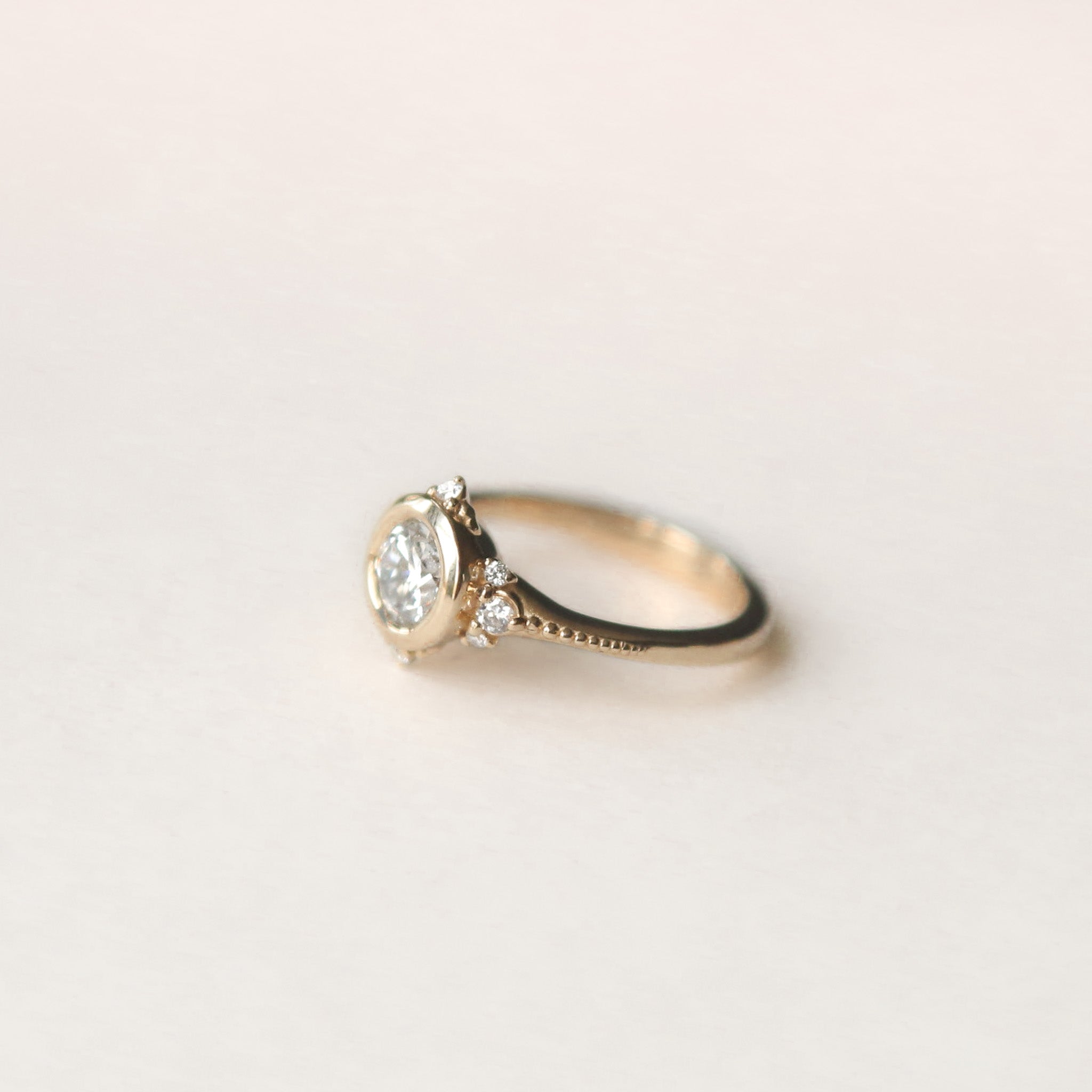 Round brilliant diamond engagement ring with tiny diamond accents - Cival Jewelry Milwaukee