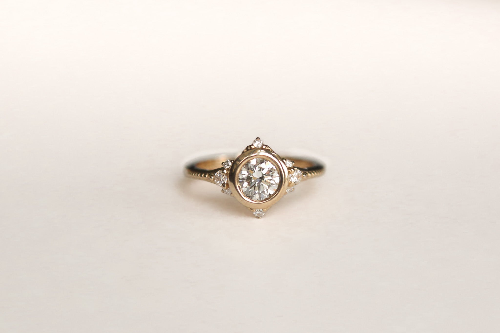 Round brilliant diamond engagement ring with tiny diamond accents - Cival Jewelry Milwaukee