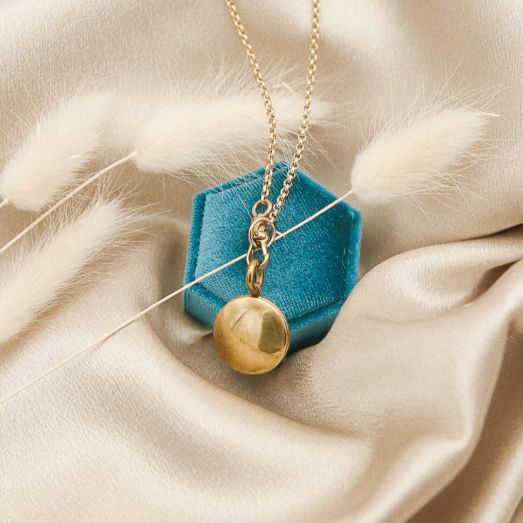 Round brass locket on a gold fill chain with a brass swivel clasp locket