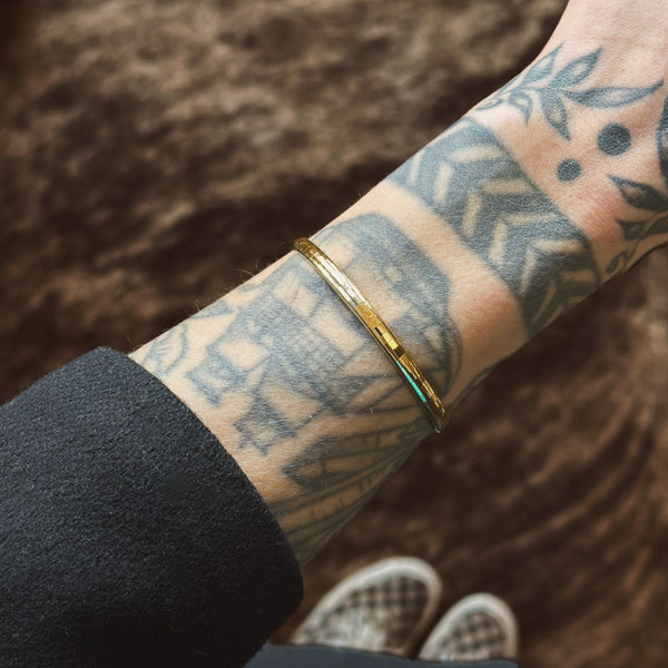close up of Italian flat wire bracelet on model, 14k gold  