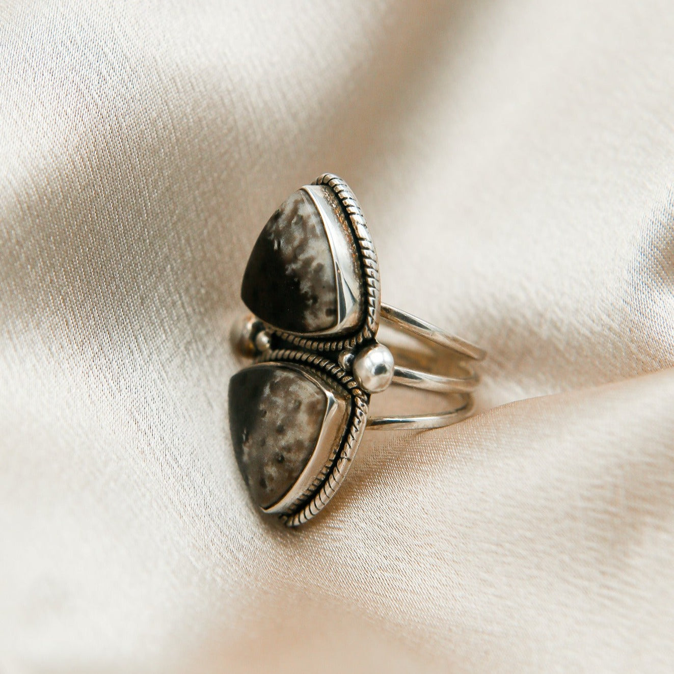 close up of double dinosaur agate ring with twisted sterling silver and bead accents