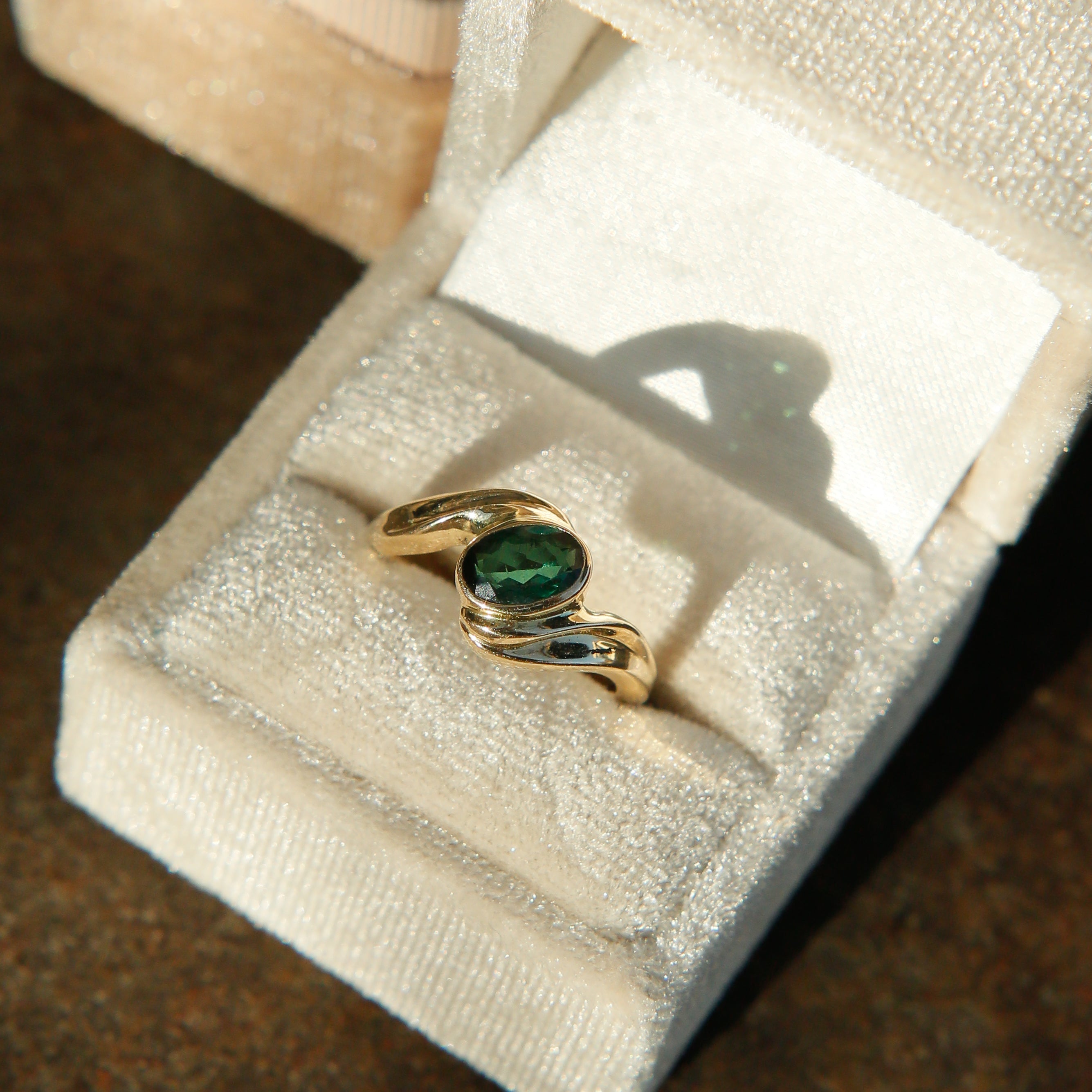 sleek vintage ring. Green tourmaline stone with gold band. Bypass design. Sold at Cival Collective in Milwaukee Wisconsin