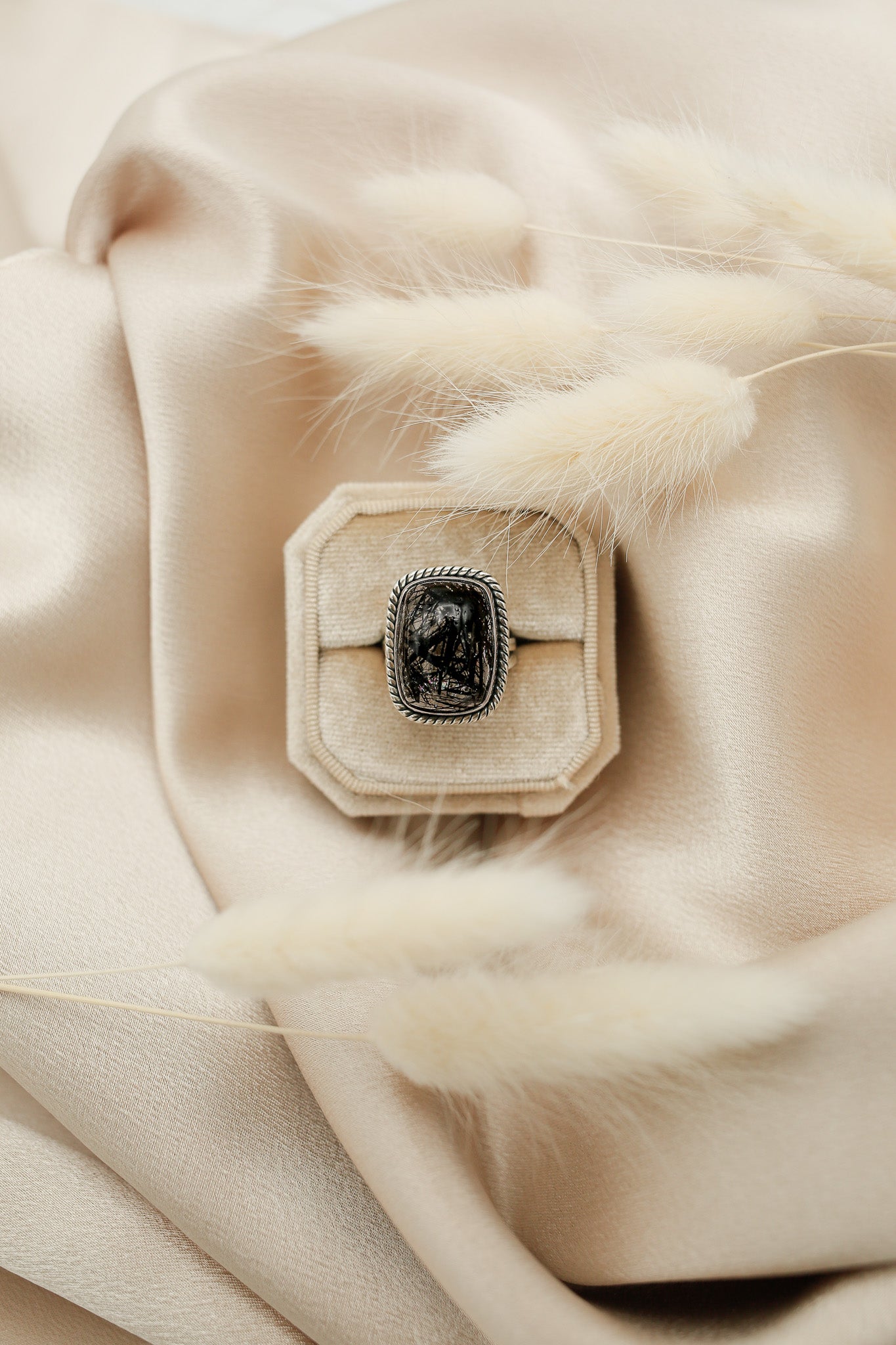 Black tourmaline in clear quartz rectangle ring in a cream velvet ring box