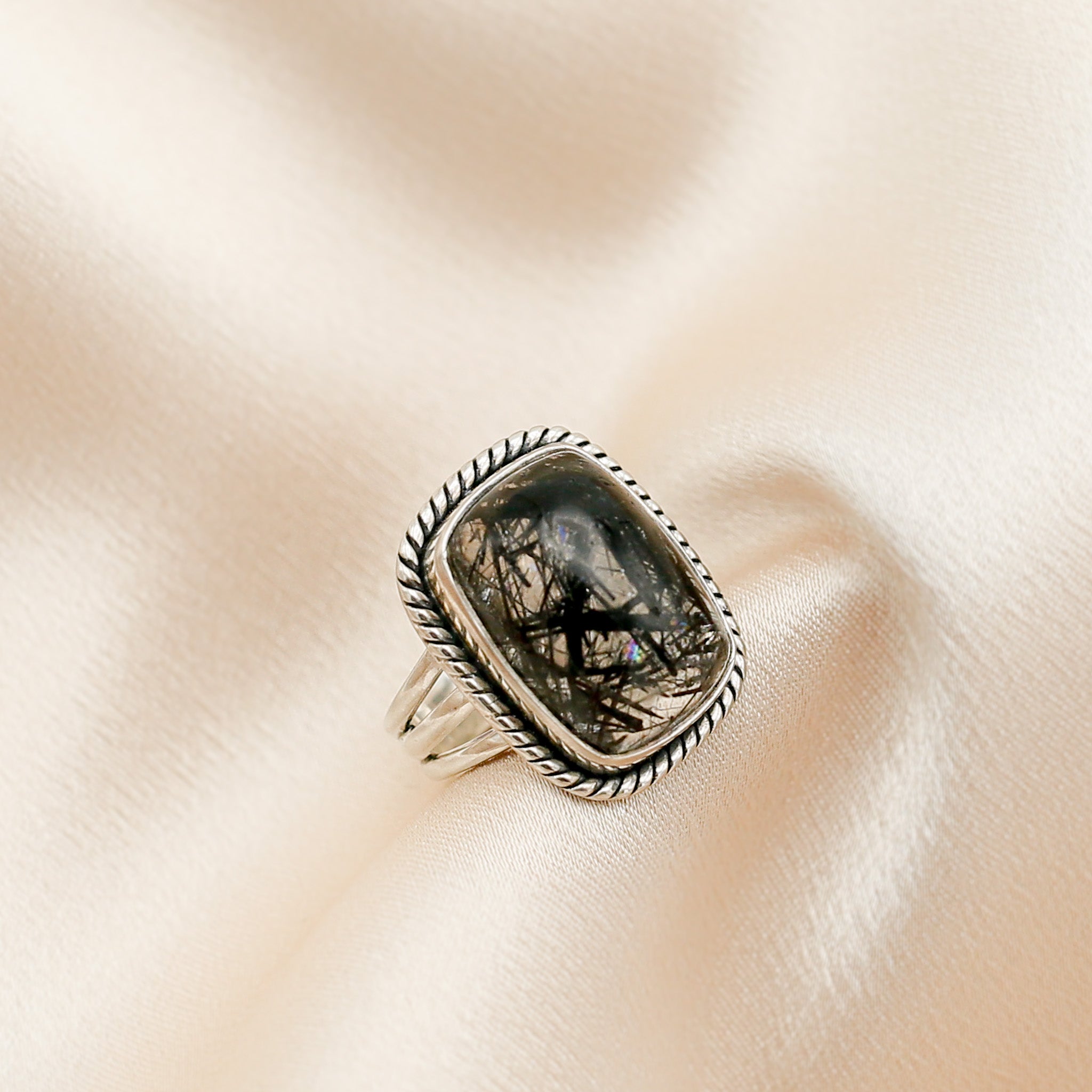 Black tourmaline in clear quartz rectangle ring side profile sowing silver band