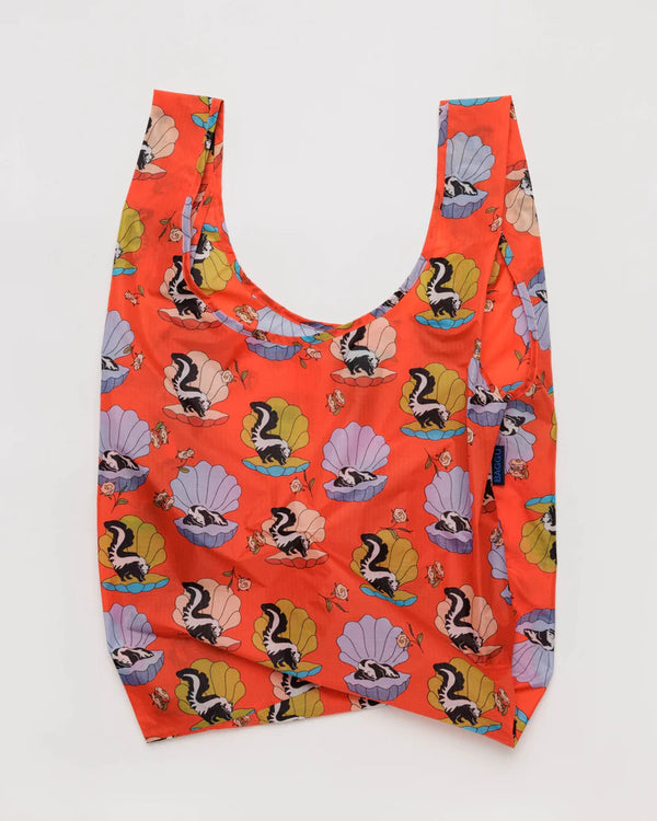 Open baggu standard size reusable bag in the half shell skunk print colors are orange blue pink green black and white with askance on a half shell and rose pattern 