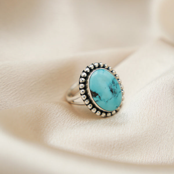 close up of hand cut vintage kingman turquoise ring 