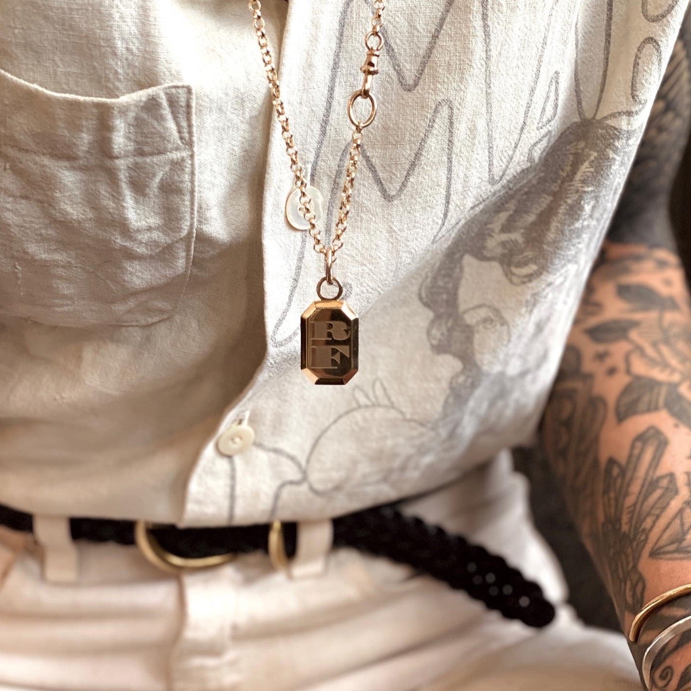 Engravable reed necklace shown on model,  cast brass designed by cival collective