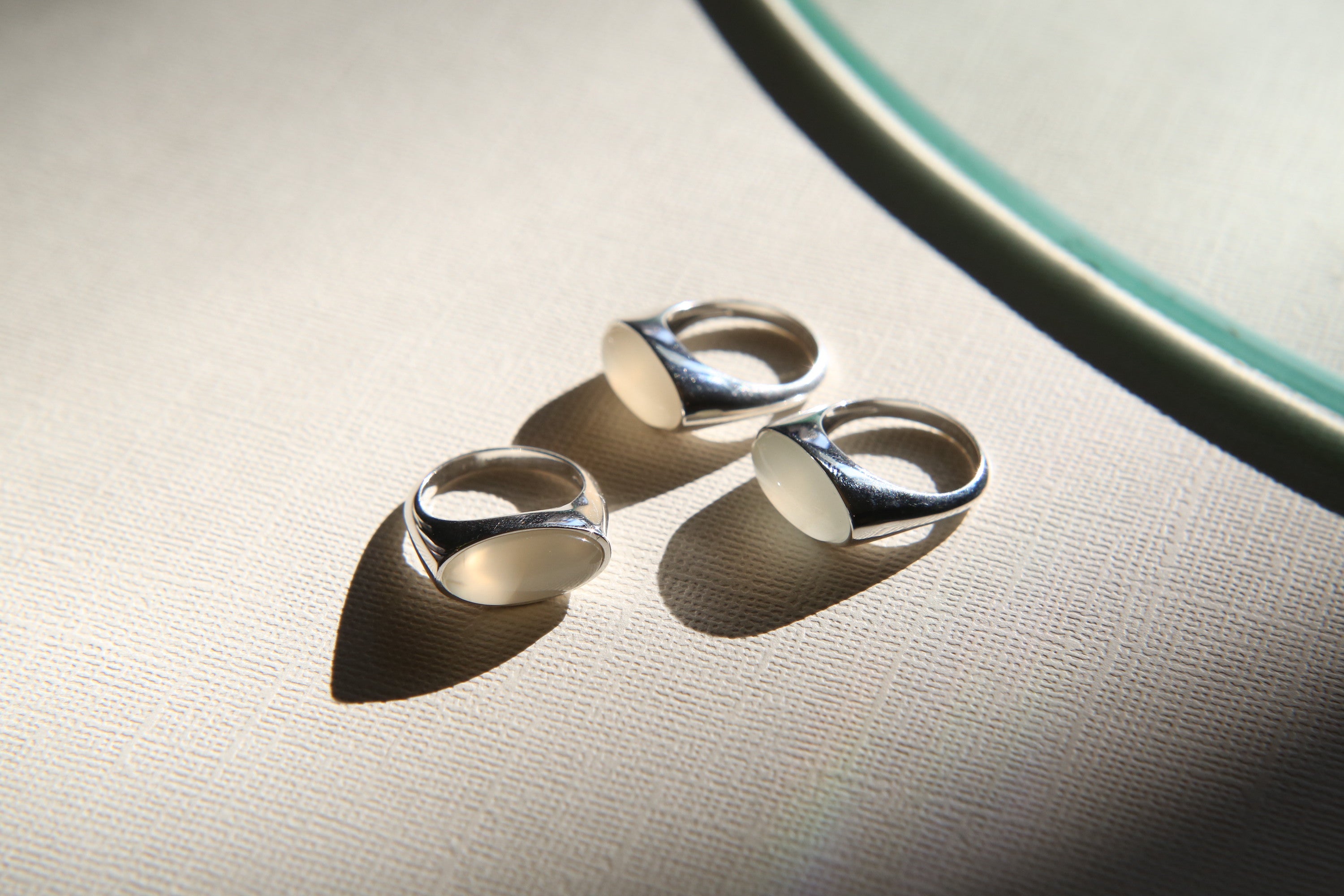 Three Sterling silver dome rings with cloudy white oval stones