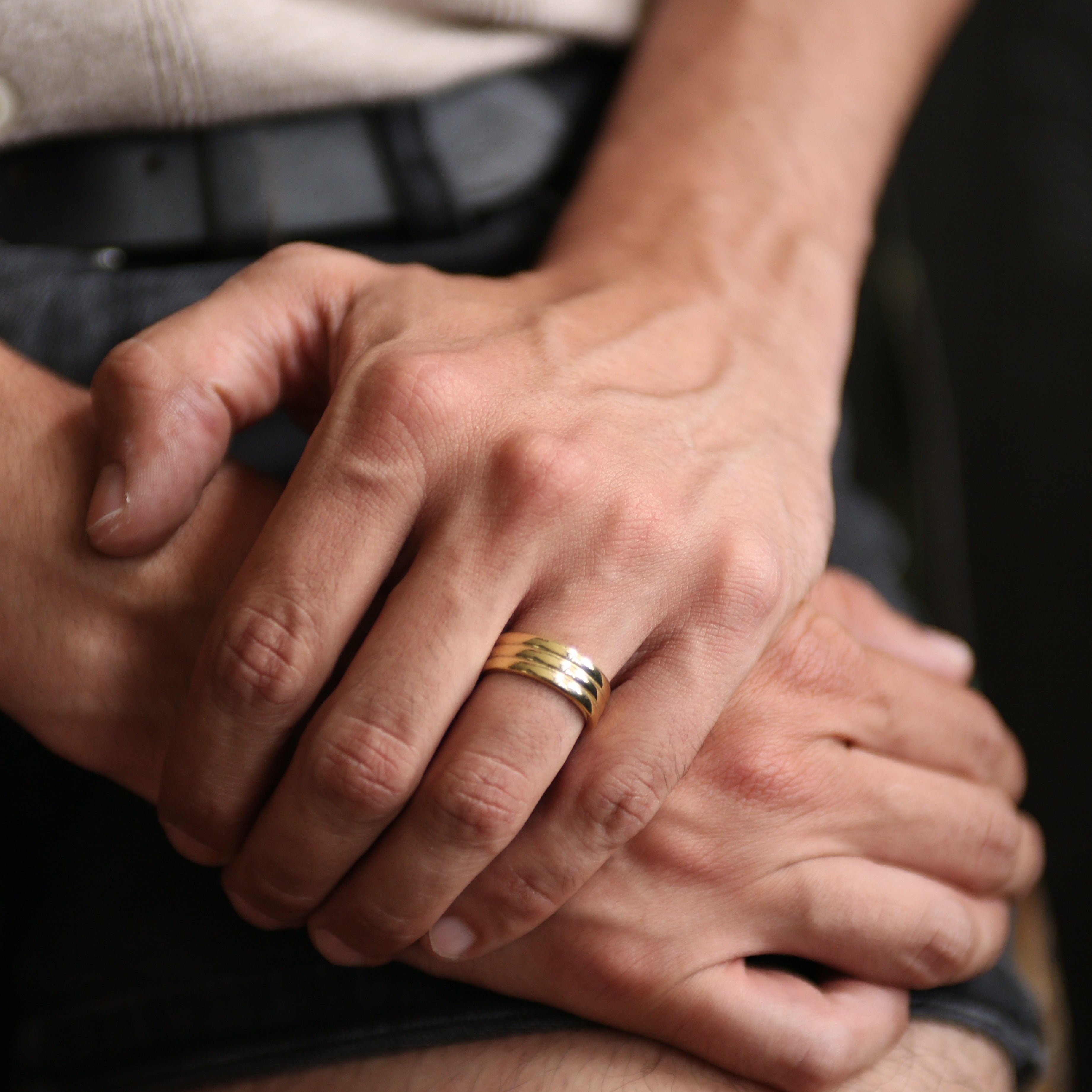 close up of ella ring on model, brass east to west striped textured ring.