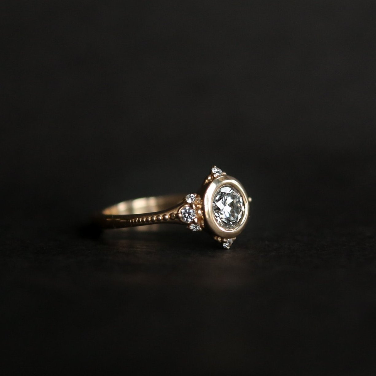 Round brilliant diamond engagement ring with tiny diamond accents - Cival Jewelry Milwaukee