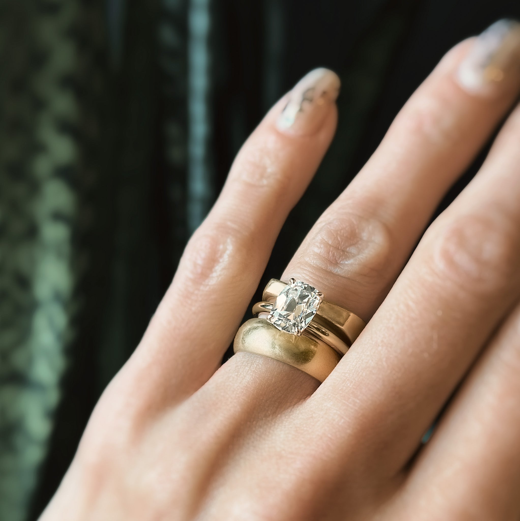 2ct Antique Cushion cut moissanite diamond engagement ring on a yellow gold band, by Unique Milwaukee Jewelry Store Cival Collective. Expertly crafted gold ring stacks with any style wedding band.