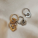 close up of silver and gold louisa earrings, hoops and flower charms earrings 