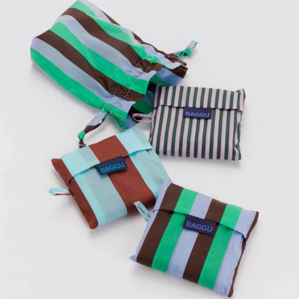 Flat lay of 3 Baggu bags in their square pouches