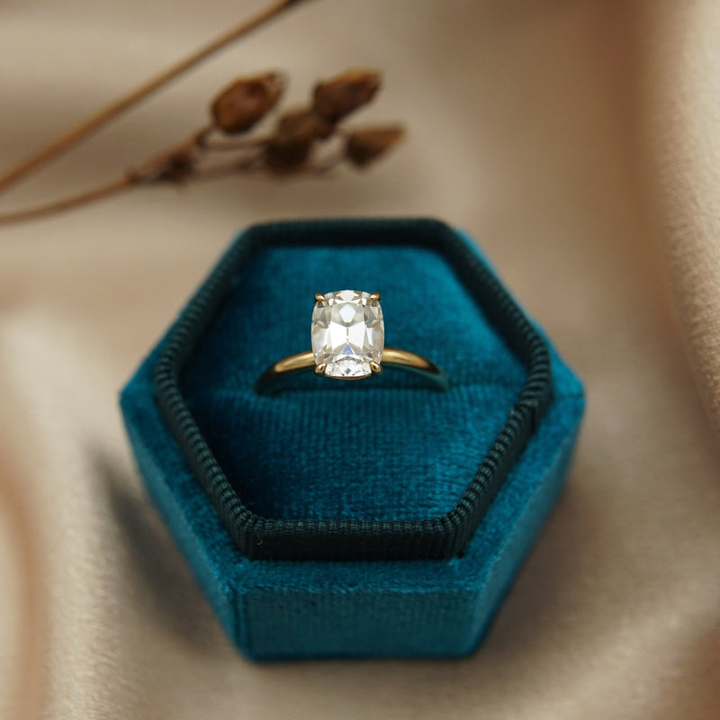 2ct Antique Cushion cut moissanite diamond engagement ring on a yellow gold band, by Unique Milwaukee Jewelry Store Cival Collective. Expertly crafted gold ring stacks with any style wedding band.  