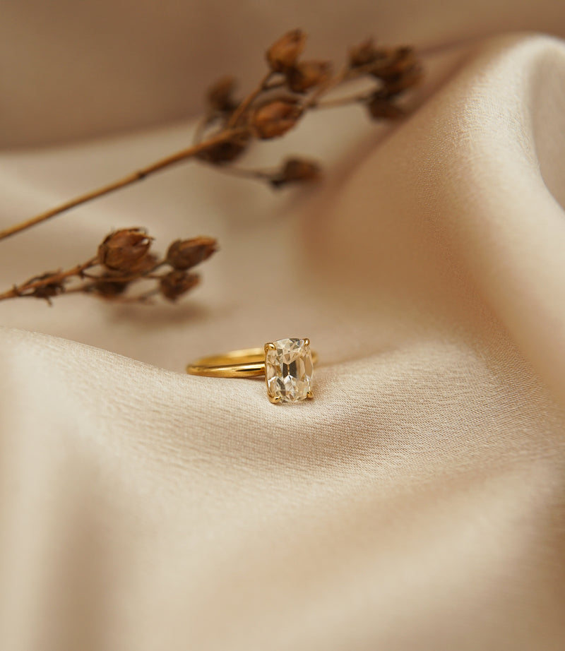 2ct Antique Cushion cut moissanite diamond engagement ring on a yellow gold band, by Unique Milwaukee Jewelry Store Cival Collective. Expertly crafted gold ring stacks with any style wedding band.