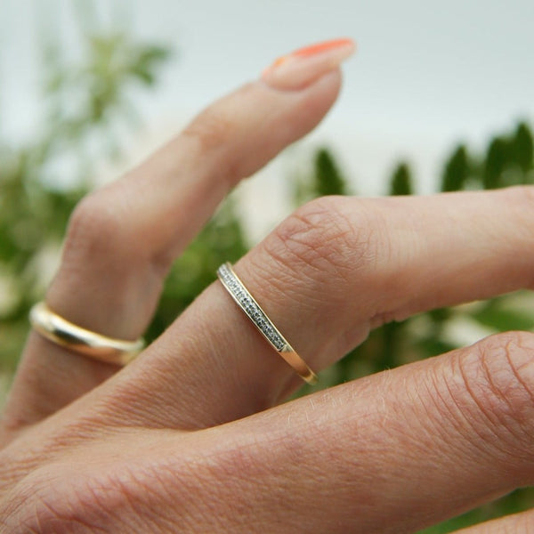 Two tone yellow gold and platinum thin pave wedding band  on hand
