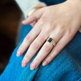 Blue sapphire ring with two rows of natural white diamonds in an architectural modern setting 