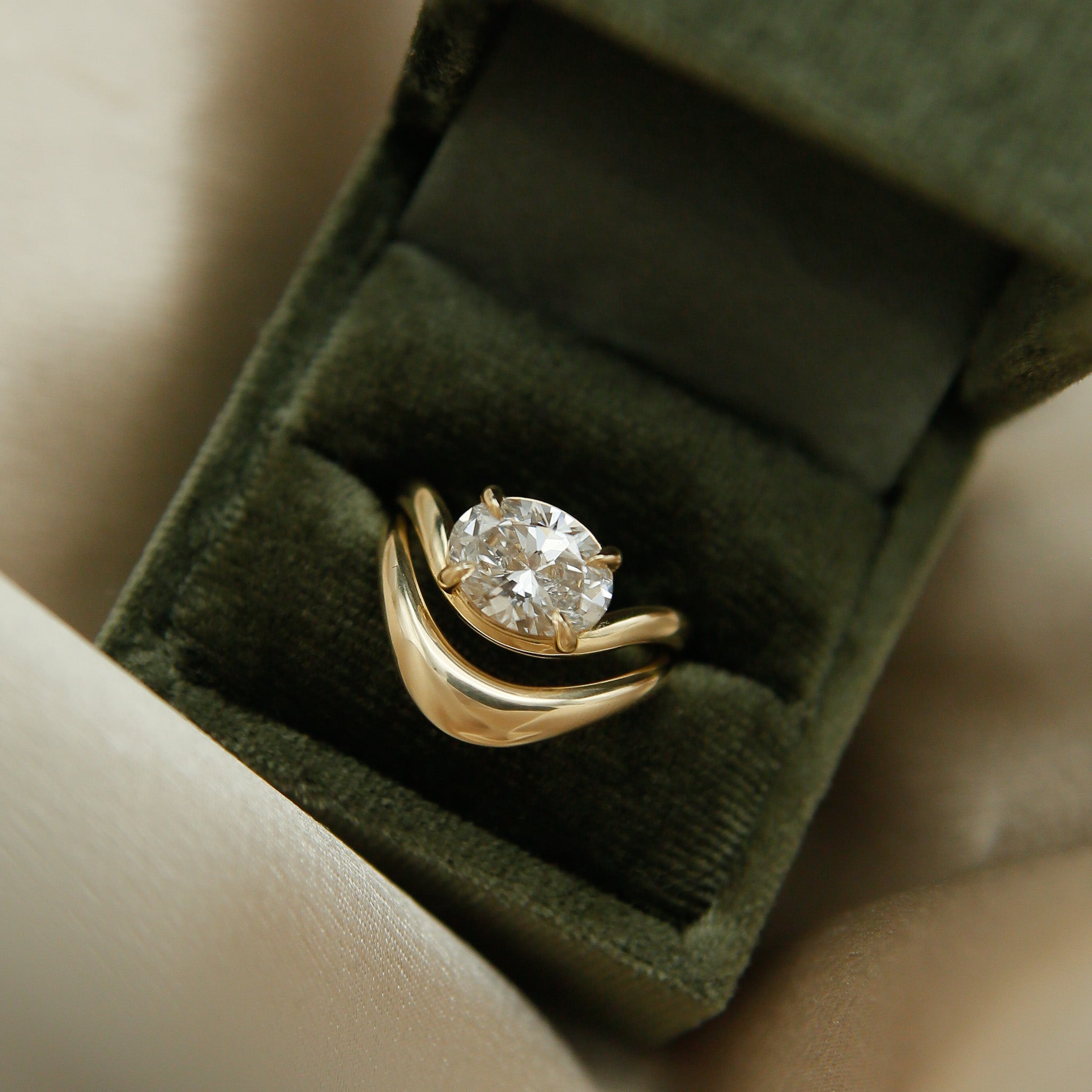 Gold wave ring with east west oval Dimond engagement ring by cival collective - Milwaukee Jewelry company 