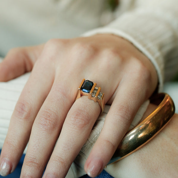 Asymetrial vintage 1960s yellow gold ring with emerald cut sapphire and rows of natural diamonds 