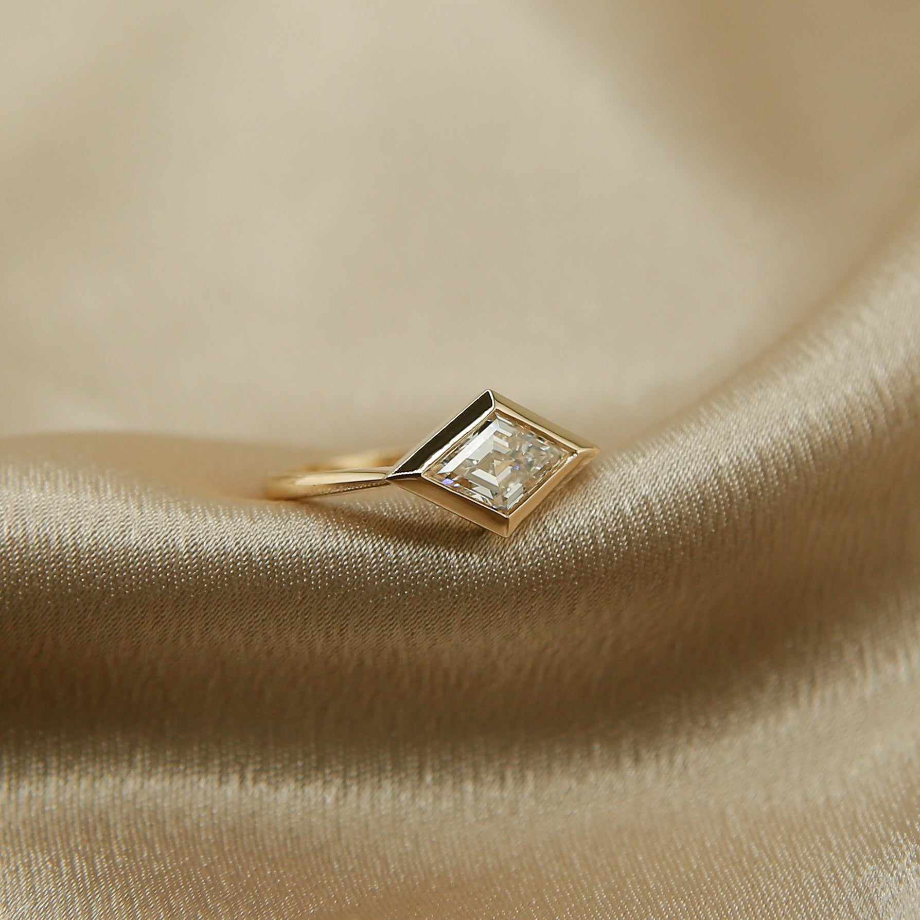 14k gold engagement ring with bezel set east west lozenge diamond. Made by Cival in Milwaukee Wisconsin. 