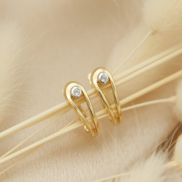 close up of 14k diamond lever back earrings 