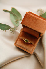 Lux rust velvet ring box containing an antique engagement ring fully repaired and restored by local retail shop Cival in Milwaukee WI