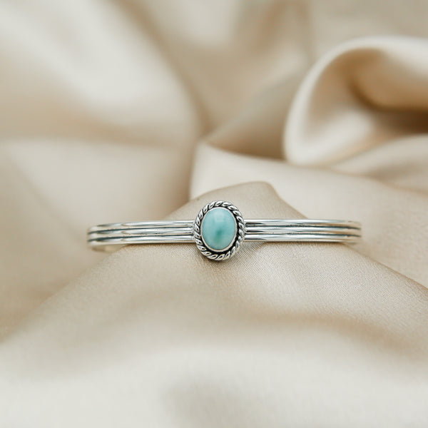 sterling silver cuff featuring a larimar stone on a twisted bezel