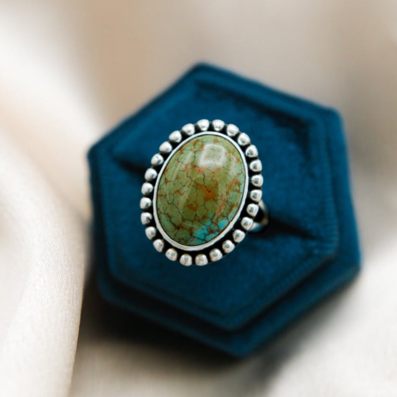 Royston turquoise oval ring with traditional silver detail by cival jewelry design company in Milwaukee wi 