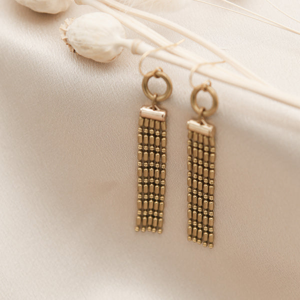 close up of emmy lou chandelier earrings made with lightweight faceted beaded brass chain