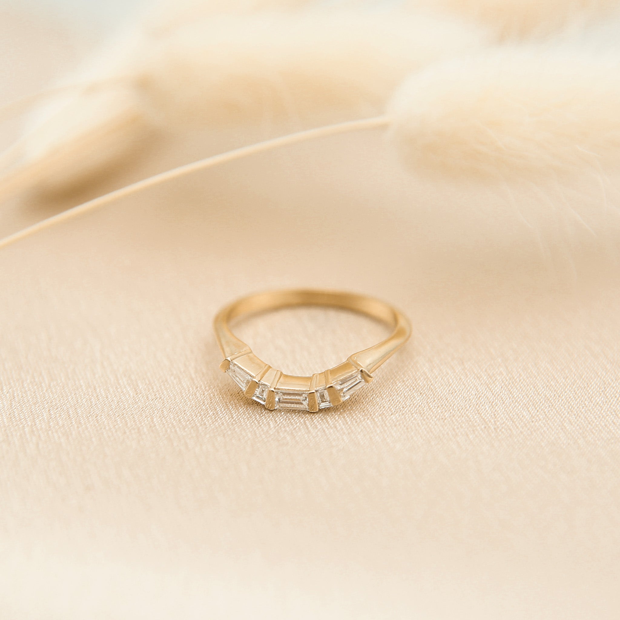 14k yellow gold modern countered wedding band with baguette diamonds 