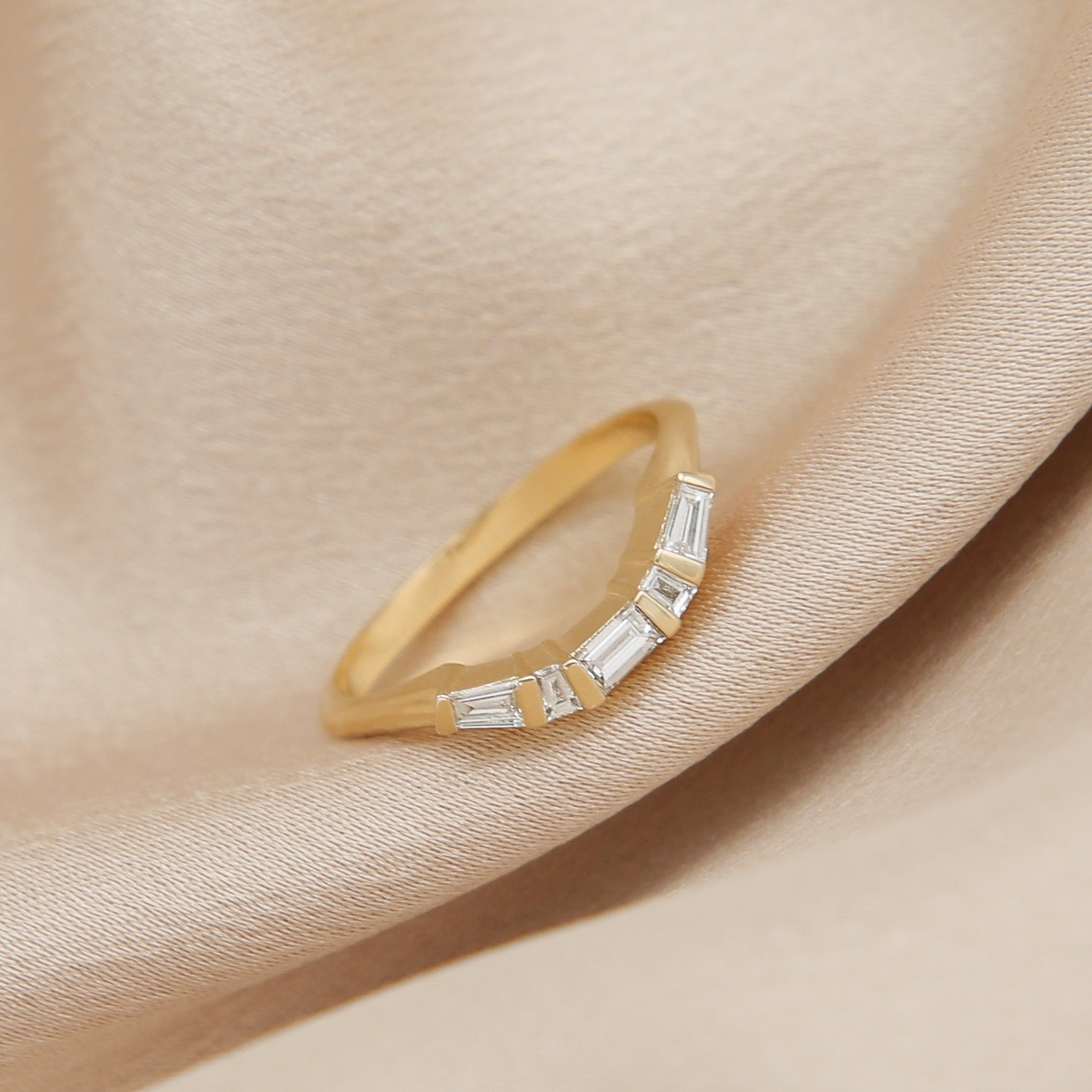 14k yellow gold modern countered wedding band with baguette diamonds 