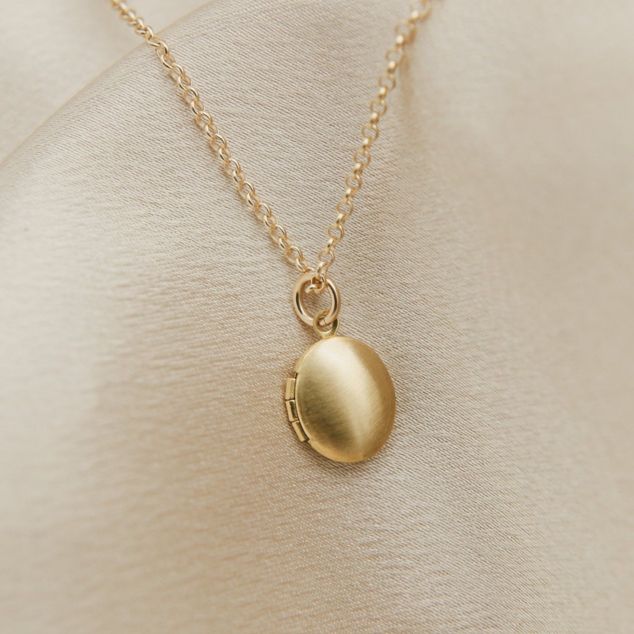 tiny oval shaped locket on gold filled chain - cival collective Jewelry Design company Milwaukee WI