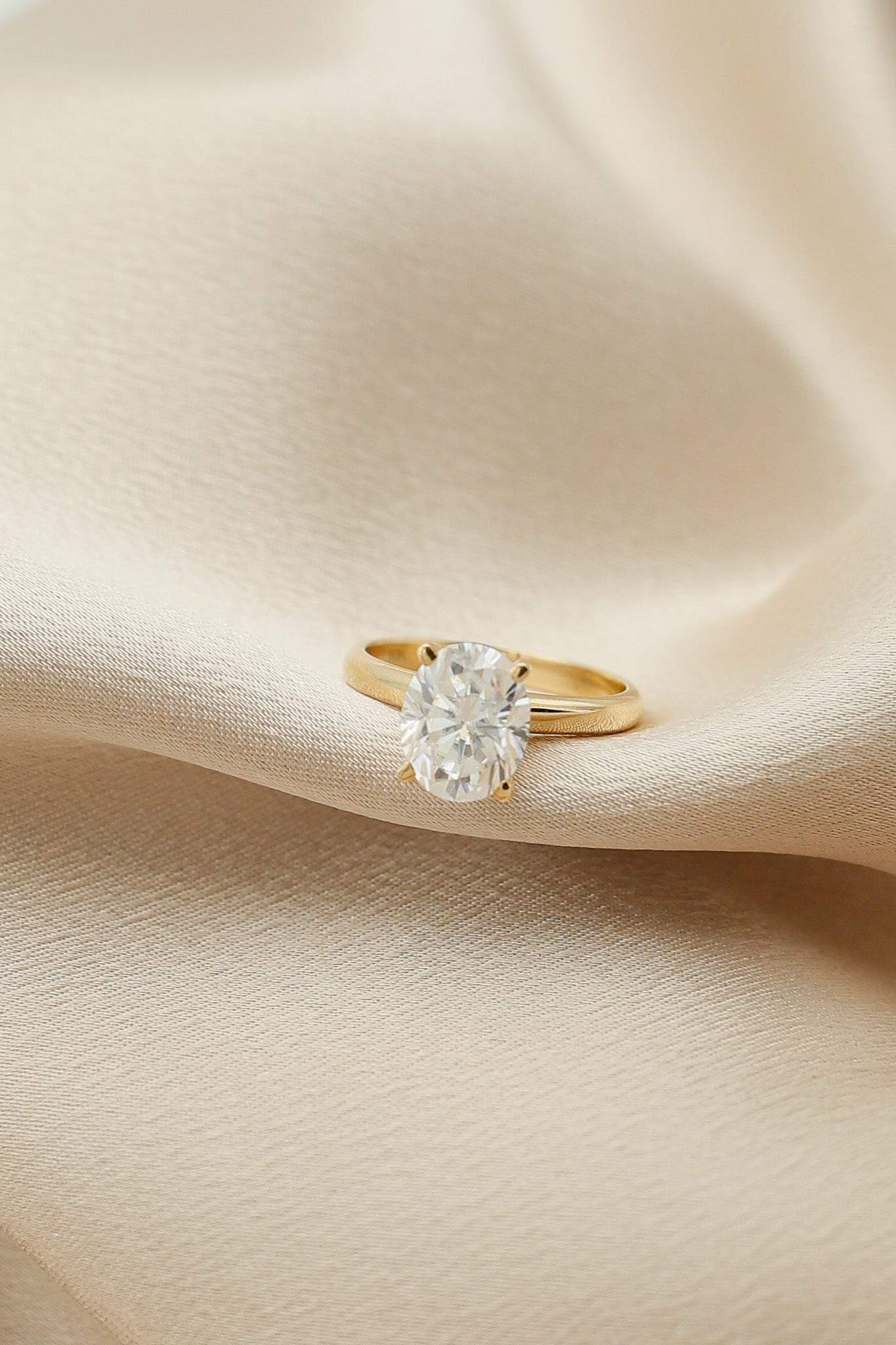 Four prong 3ct oval solitaire engagement ring in yellow gold by Cival Jewelry shop Milwaukee 