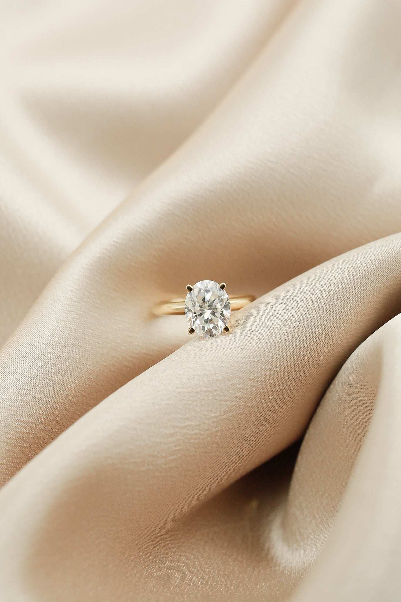 Four prong 3ct oval solitaire engagement ring in yellow gold by Cival Jewelry shop Milwaukee 