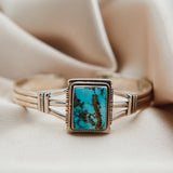 sterling silver cuff featuring a large rectangular Kingman Turquoise center stone