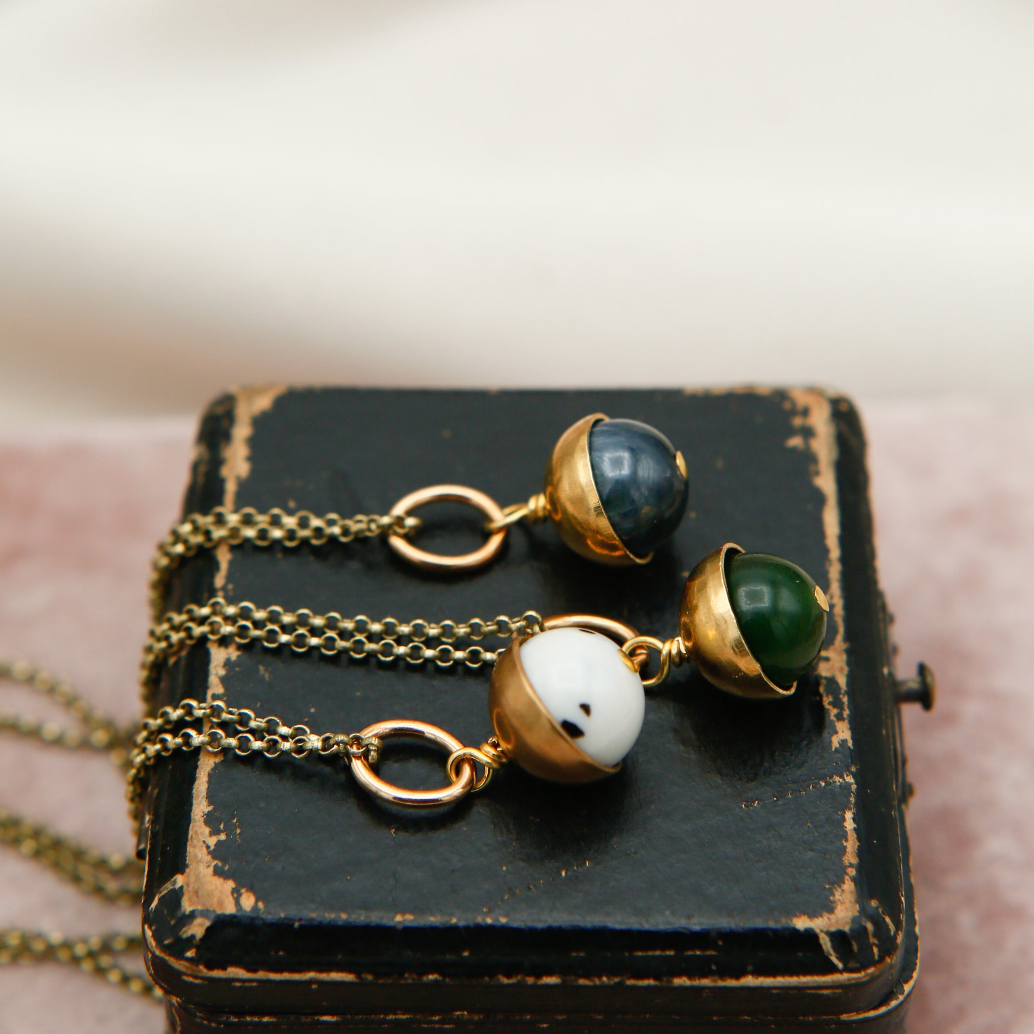 three round stone in brass caps necklaces