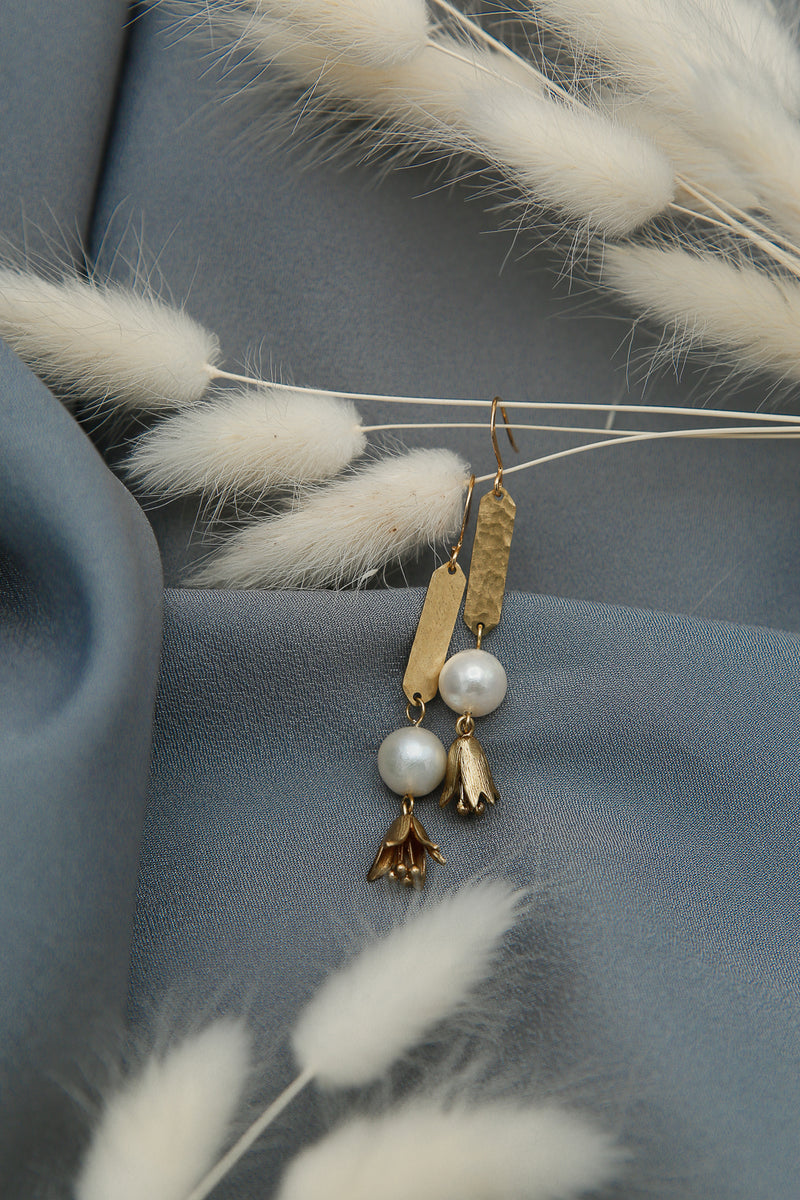 Pearl earrings with textured brass and flower drops 