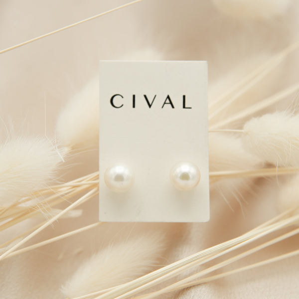 close up of pearl stud earrings. 