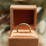 close up of 10k 3mm round solid gold ring in velvet box 