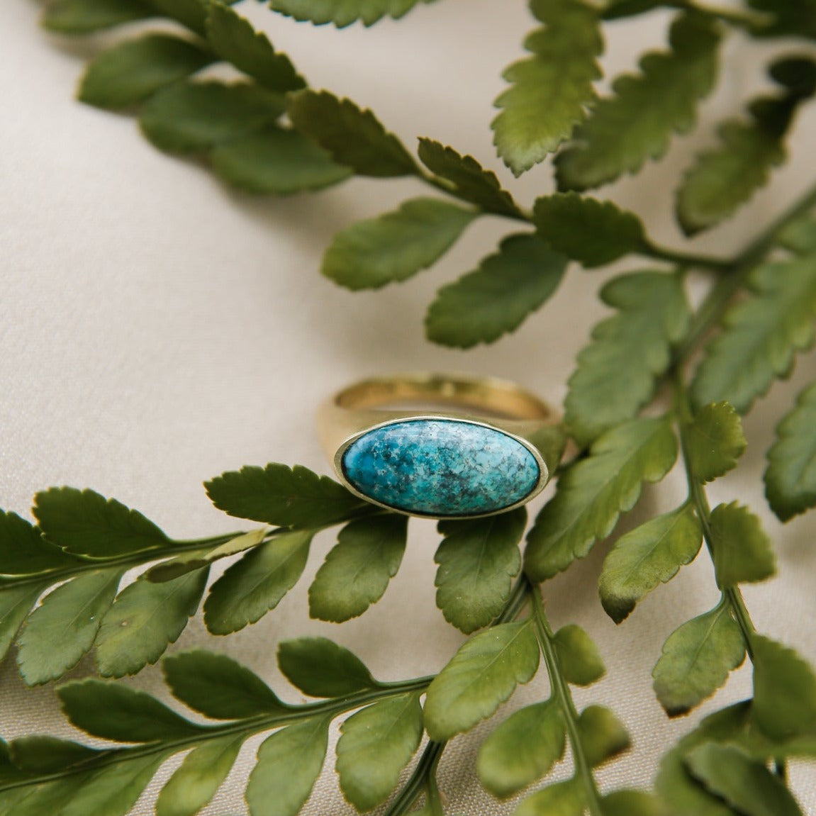 elongated oval signet style turquoise ring in brass or sterling setting 