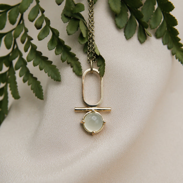 Brass pendant with a ghost jade center stone designed in house at Cival Collective, a jewelry store in Milwaukee, WI