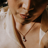 9.5 mm cast brass pendant with moonstone on model. designed by cival collective