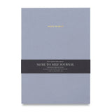 Light blue "Note to Self" journal made by Wit & Delight shown with black informational belly band.