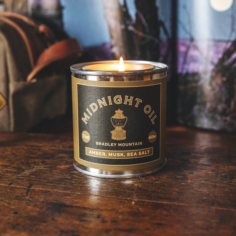 candle tin labeled "midnight oil" 