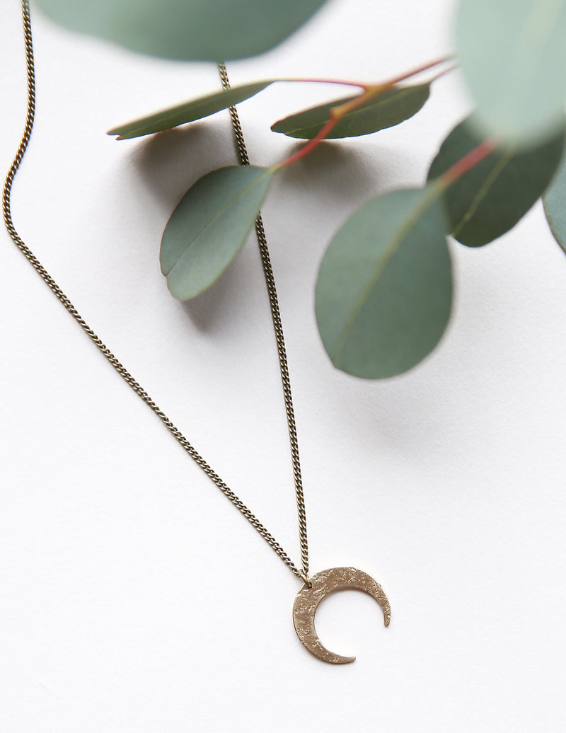 Dainty brass moon necklace hand made by jewelry designers, Cival Collective, from the USA..
