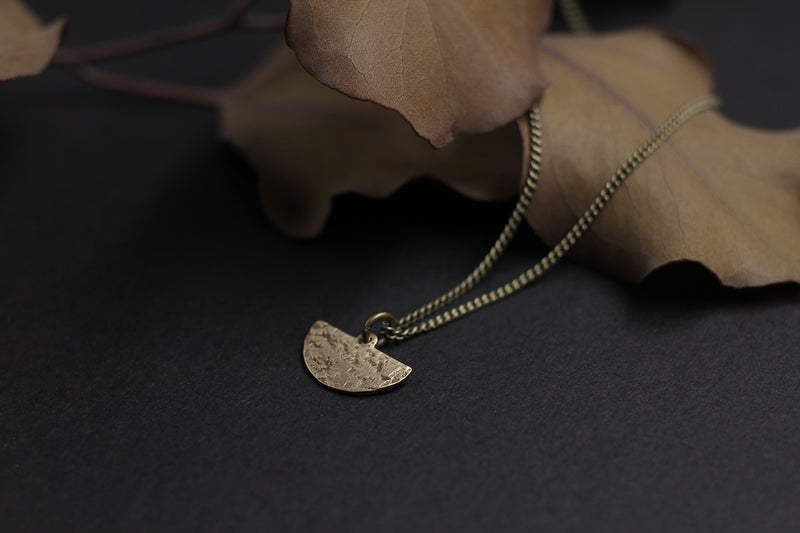 Delicate brass moon necklace handmade by Milwaukee jewelry designers, Cival Collective.