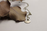Delicate brass moon necklace handmade by Cival Collective.