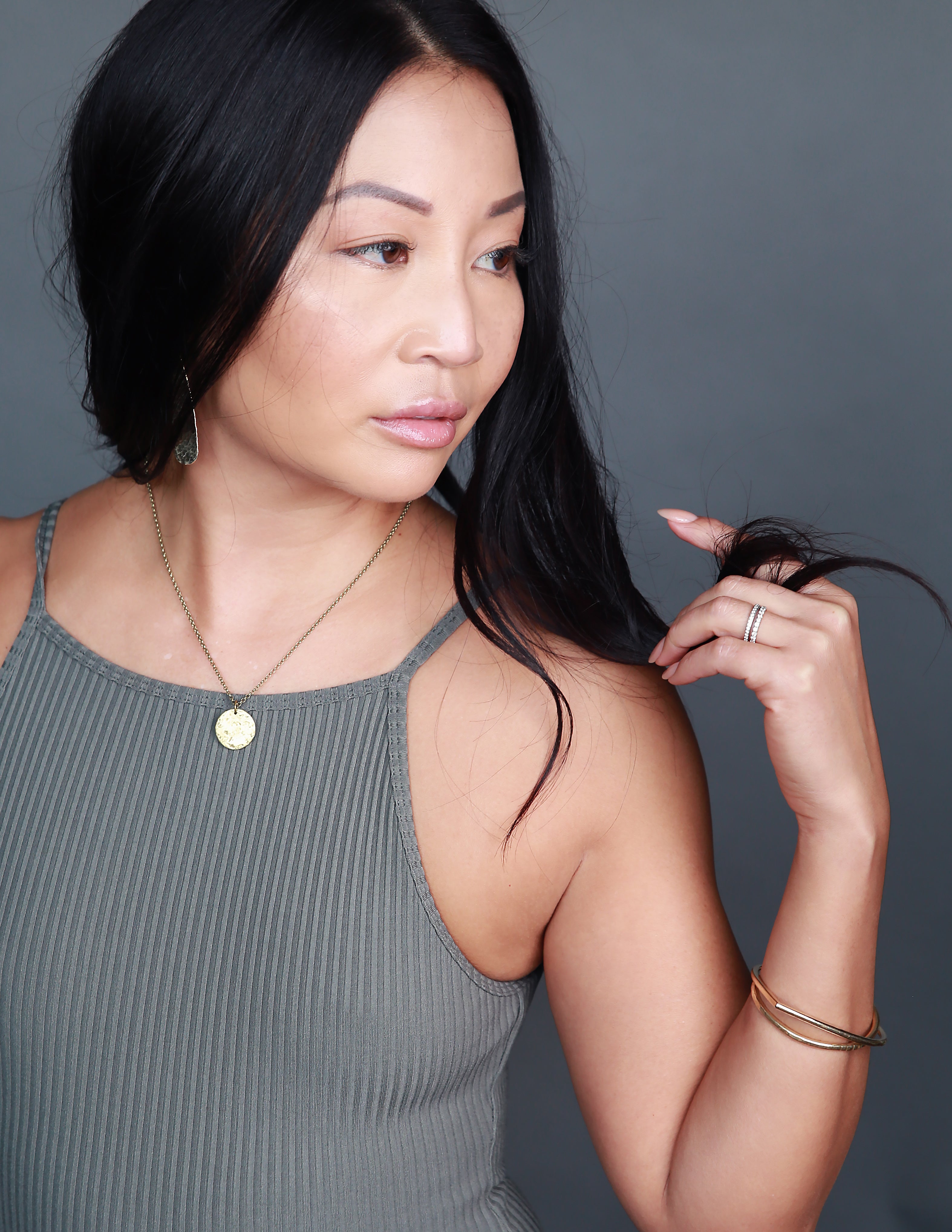 Model wearing classic necklace handmade by local Milwaukee jewelry designers, Cival Collective.