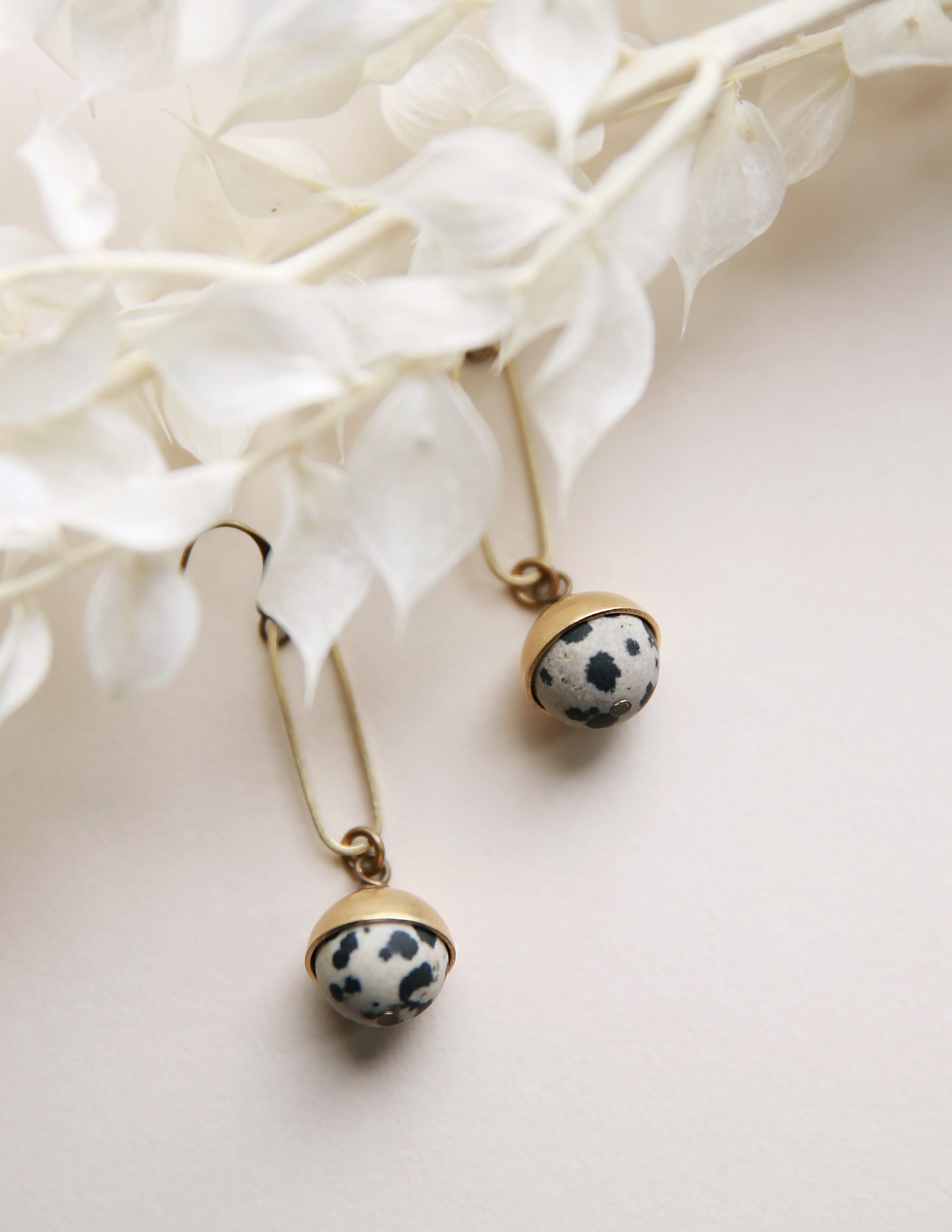 Dalmatian Jasper and brass earrings crafted by local Milwaukee Jewelry Designers, Cival Collective.